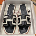 Hermes 0RAN Sandals in Black Calfskin and White Canvas