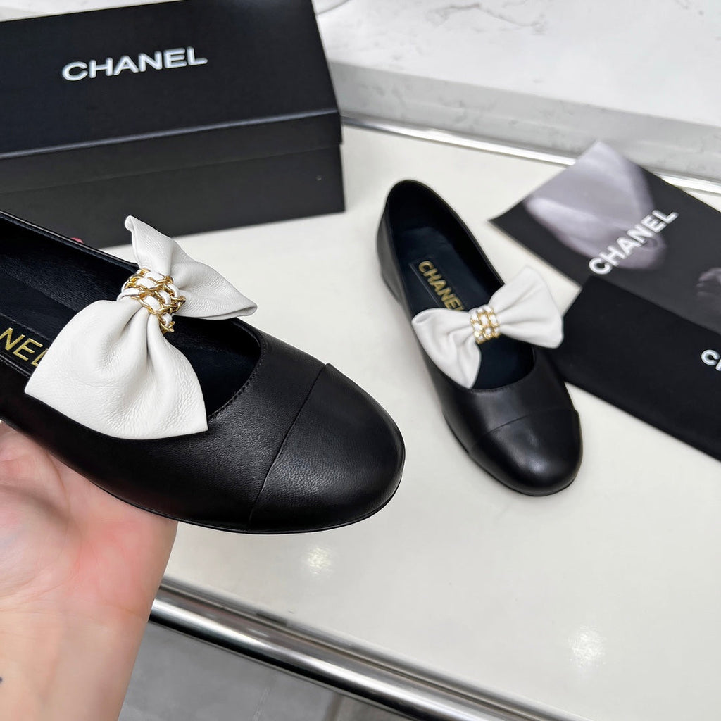 Chanel 25S Mary Janes in Black Calfskin with White Bow Gold Hardware
